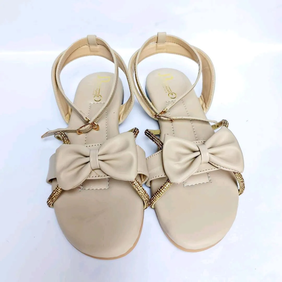 *Product Name*: Beige PU Leather Bow Sandals for Women with Gold Straps
*Product Description*: These elegant beige sandals are perfect for Pakistani women who want stylish footwear that matches both casual and festive occasions. Designed with a soft PU le